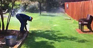 Irrigation contractor in Lakewood WA adjusts a large coverage spray head